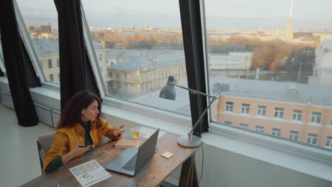 Businesswoman-Video-Calling-on-Laptop-in-Rooftop-Office